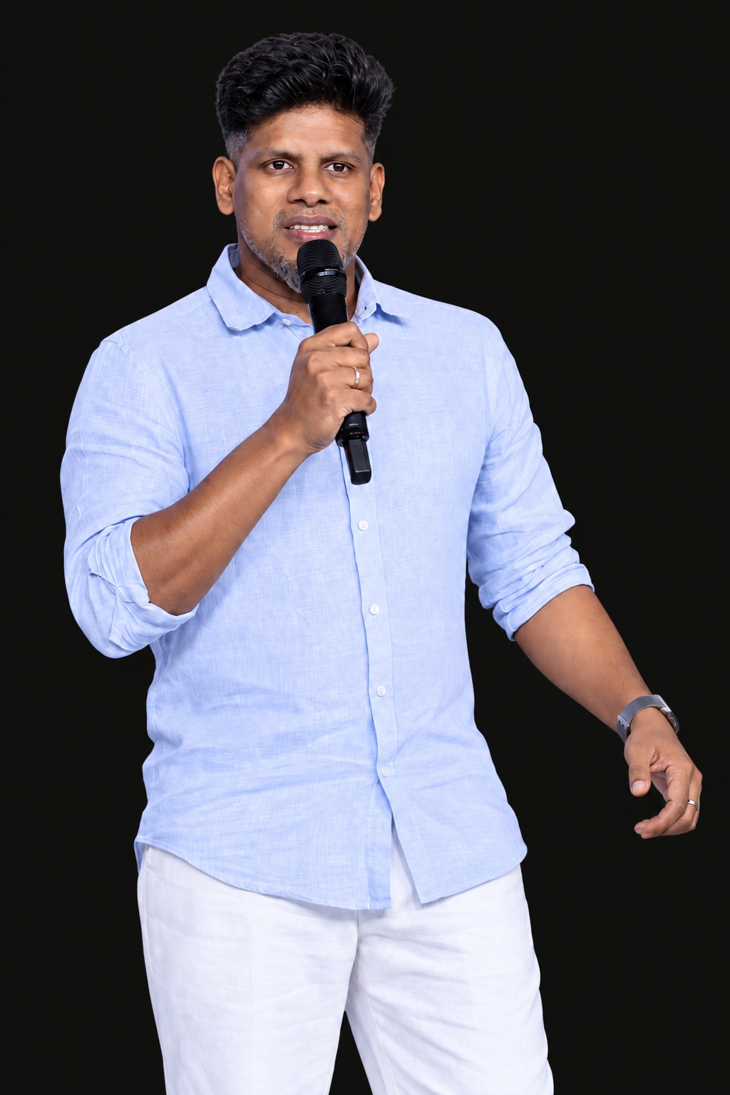 Bro. Sam holding a microphone.